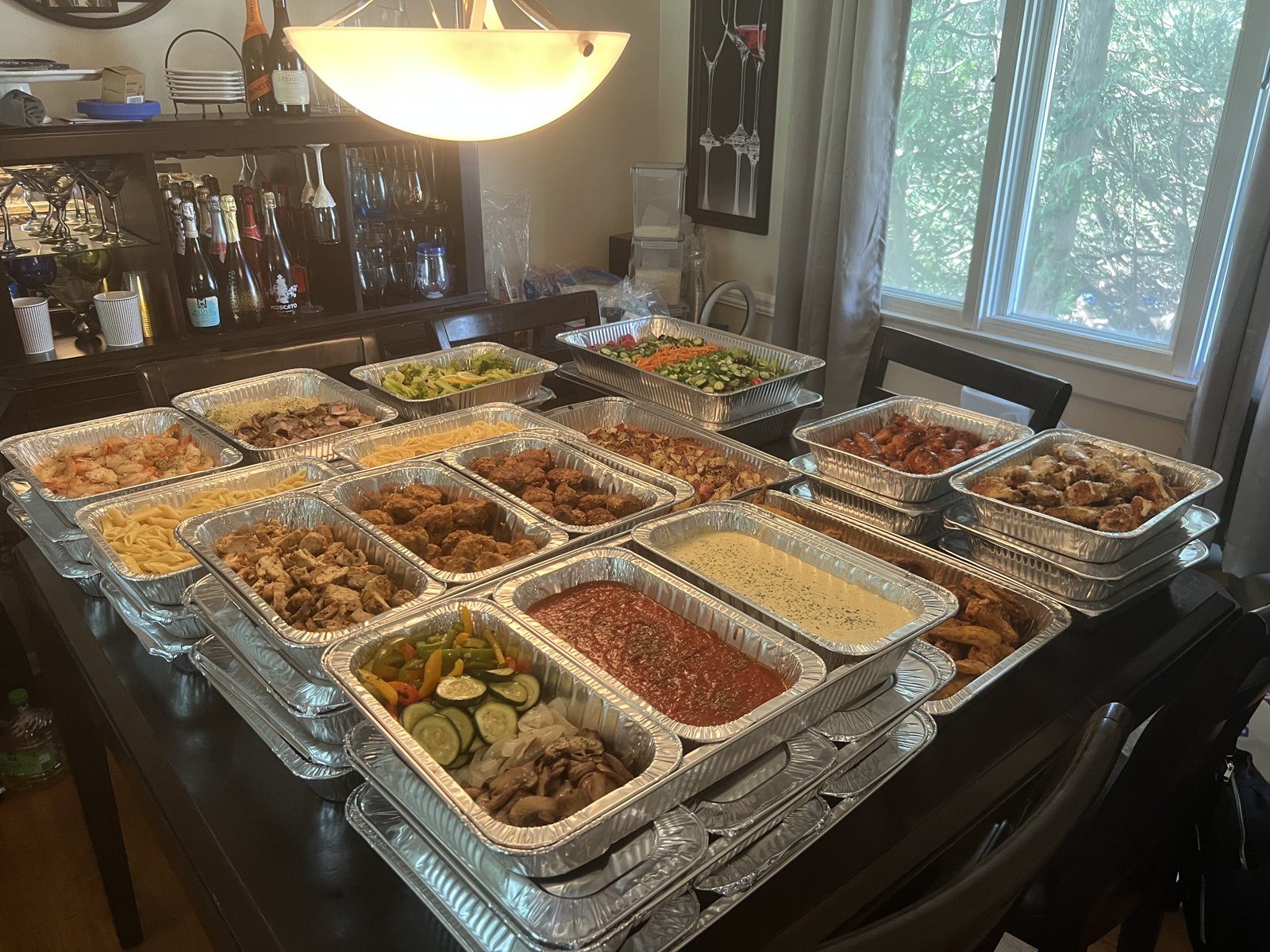 A full spread of Plated by Patrice catering trays on a dining table